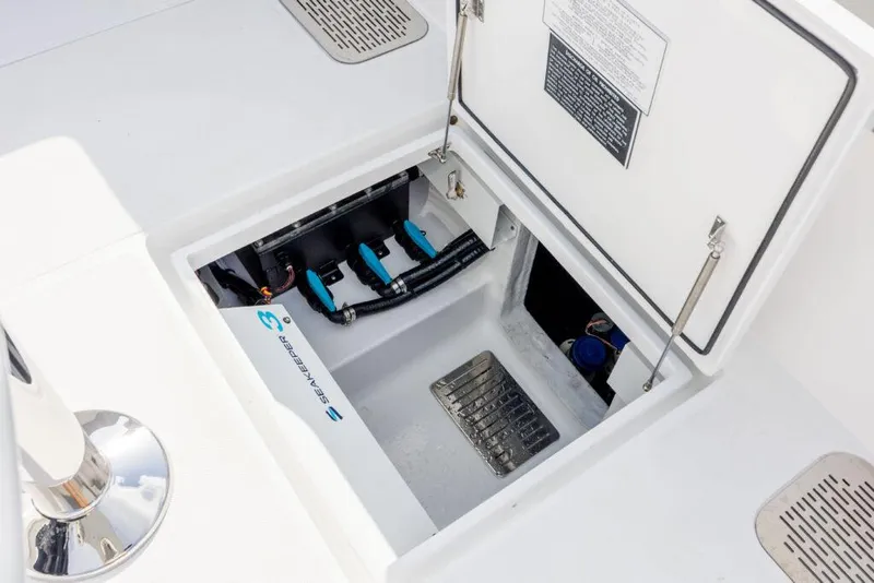 Slide: The Image of Open hatch on 2026 Front Runner 39 Center Console boat, revealing storage compartment. - 18