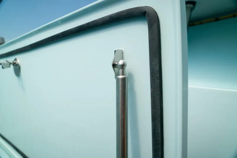 Slide: The Image of Close-up of a 2026 Front Runner 39 Center Console boat detail, featuring sleek metal and rubber trim. - 23