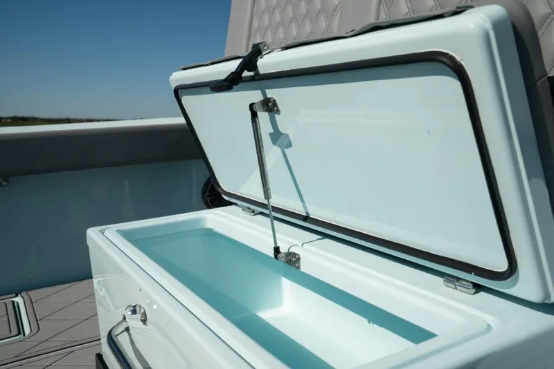 Slide: The Image of Open storage compartment on 2026 Front Runner 39 Center Console boat, showcasing interior design. - 32
