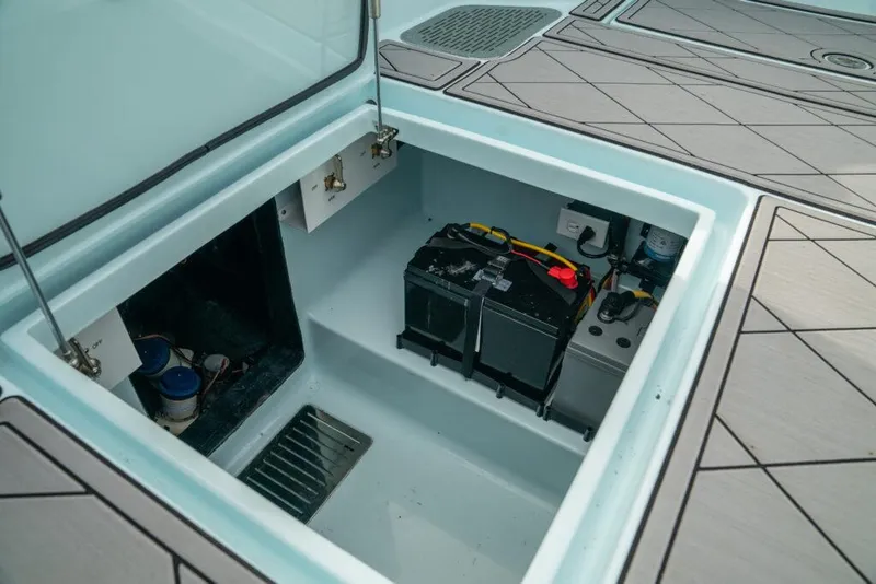 Slide: The Image of 2026 Front Runner 39 Center Console boat battery compartment with wiring and components. - 34