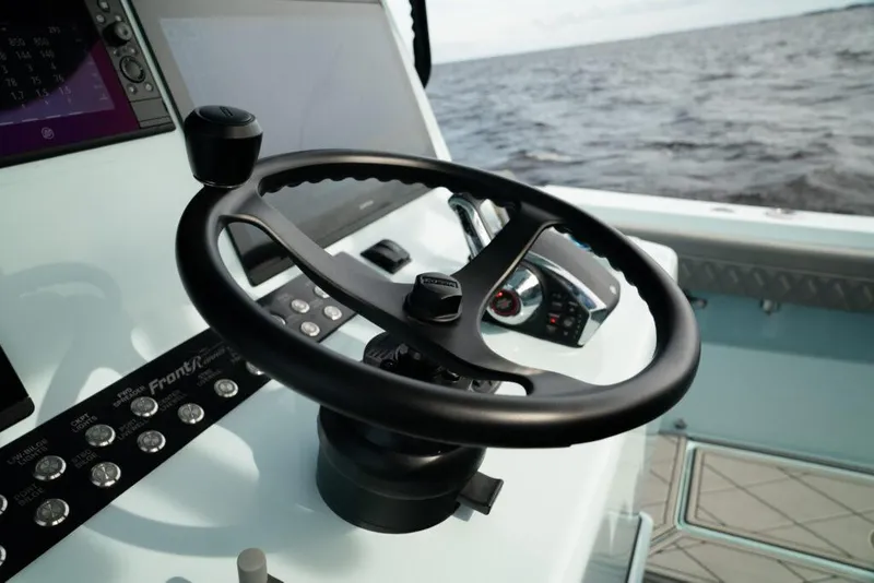 Slide: The Image of Steering wheel of 2026 Front Runner 39 Center Console boat with ocean view. - 43