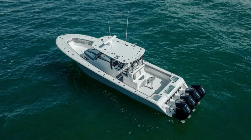 Slide: The Image of 2026 Front Runner 39 Center Console boat on open water, featuring multiple outboard engines. - 5