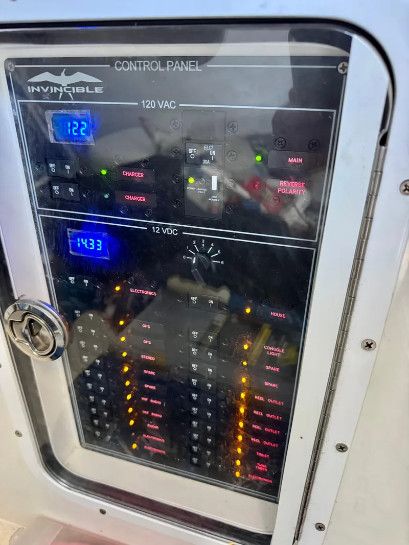 Slide: The Image of Control panel of 2022 Invincible 46 Catamaran displaying 120 VAC and 12 VDC systems. - 11