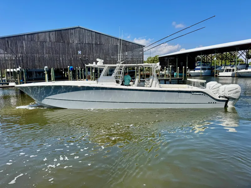 The Image of 2022 Invincible 46 Catamaran docked at marina, clear sky, calm water. - 13