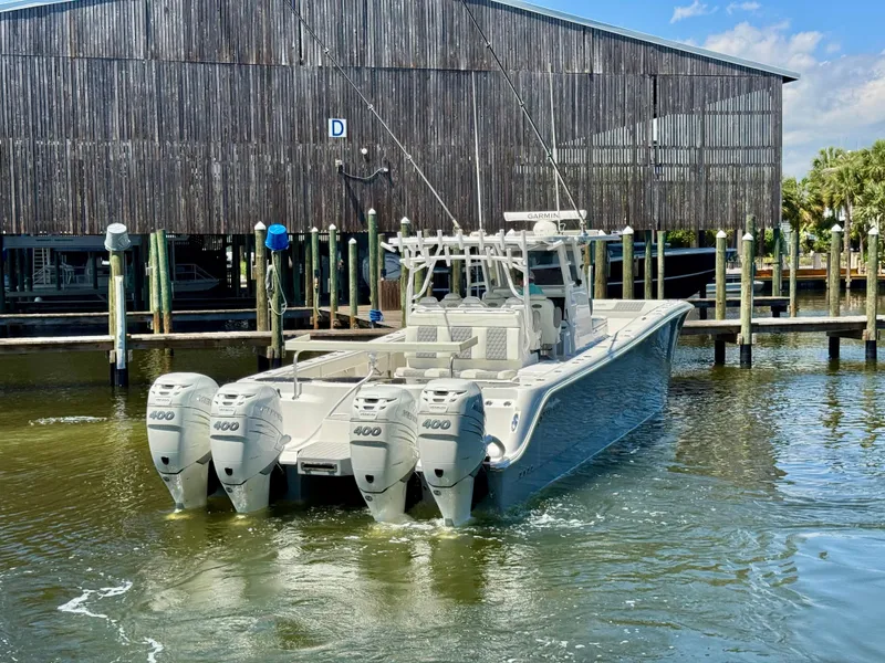 Slide: The Image of 2022 Invincible 46 Catamaran with quad engines docked at a marina. - 15