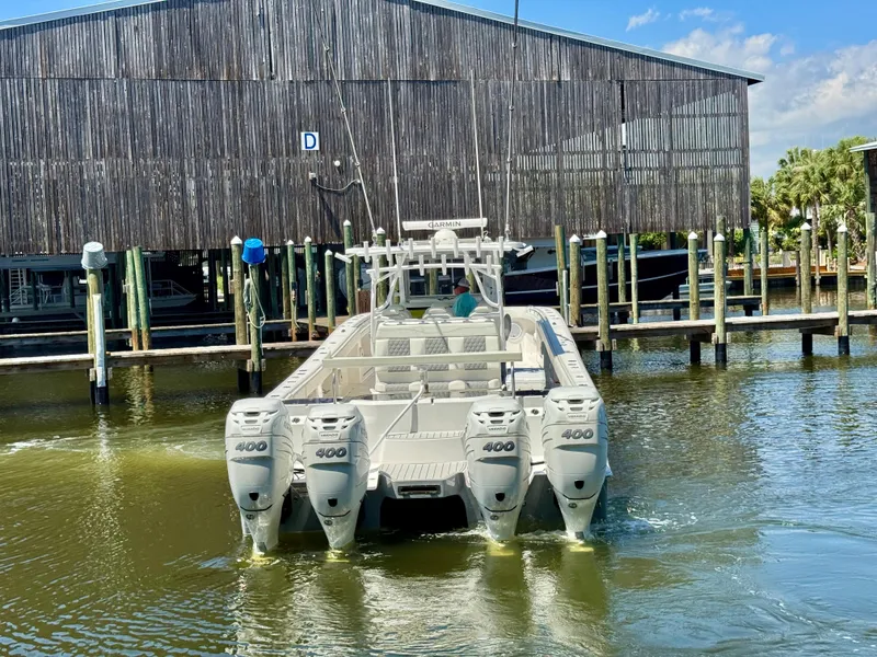 Slide: The Image of 2022 Invincible 46 Catamaran with quad engines docked at marina. - 16