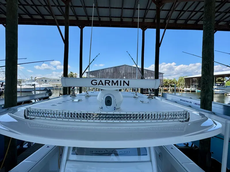 Slide: The Image of 2022 Invincible 46 Catamaran with Garmin equipment docked under a covered marina. - 23
