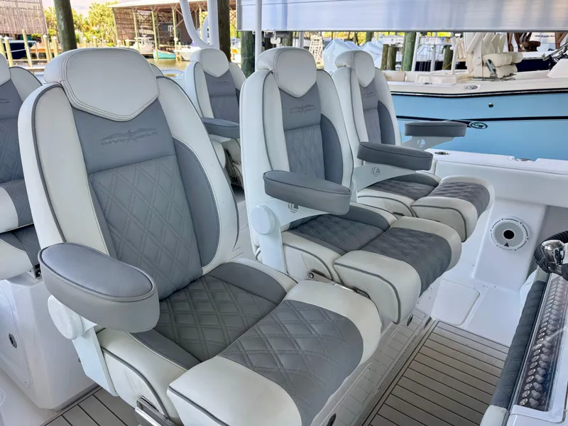 Slide: The Image of Luxurious seating on 2022 Invincible 46 Catamaran, featuring elegant gray and white upholstery. - 26