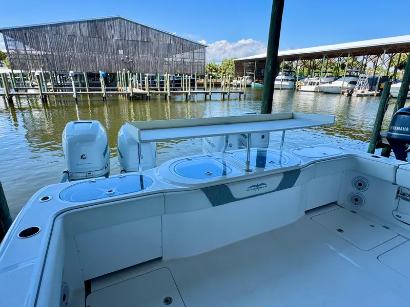 Slide: The Image of 2022 Invincible 46 Catamaran at marina, featuring spacious deck and dual engines. - 28