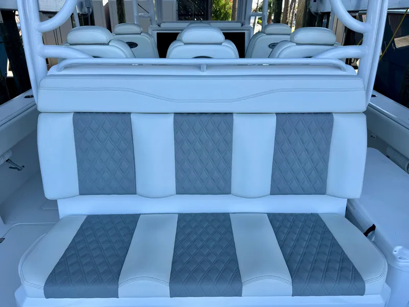 Slide: The Image of Luxurious seating on 2022 Invincible 46 Catamaran, featuring elegant white and gray upholstery. - 30