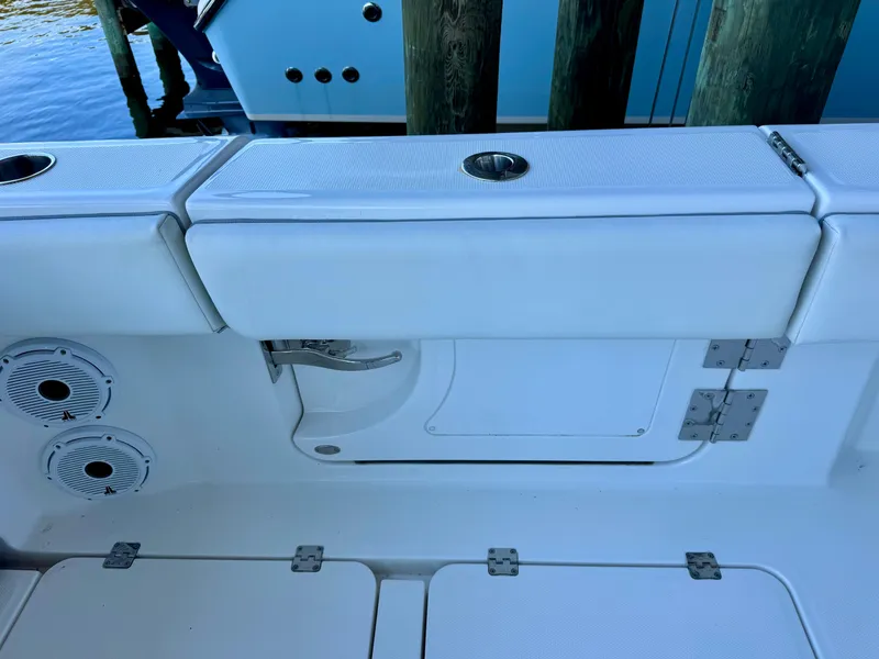 Slide: The Image of 2022 Invincible 46 Catamaran interior with white seating and storage compartments. - 32