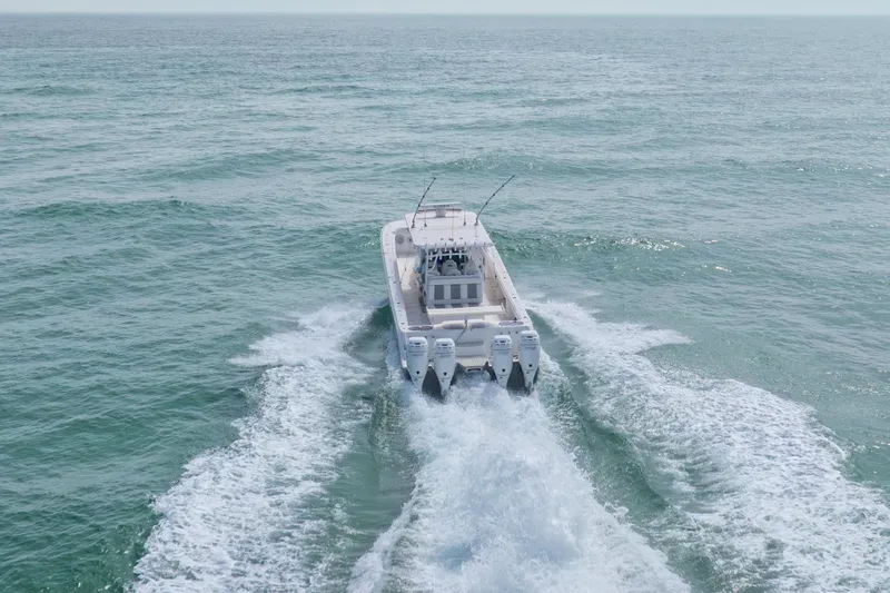 Slide: The Image of Invincible 46 Catamaran 2022 cruising on open sea, rear view. - 36