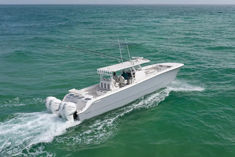 Slide: The Image of 2022 Invincible 46 Catamaran cruising on open sea with twin outboard engines. - 37