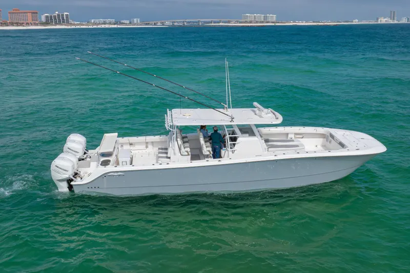 Slide: The Image of 2022 Invincible 46 Catamaran cruising on turquoise ocean near coastal cityscape. - 39