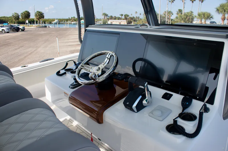 Slide: The Image of Helm of 2026 Front Runner 43 Catamaran with modern controls and dual screens. - 11