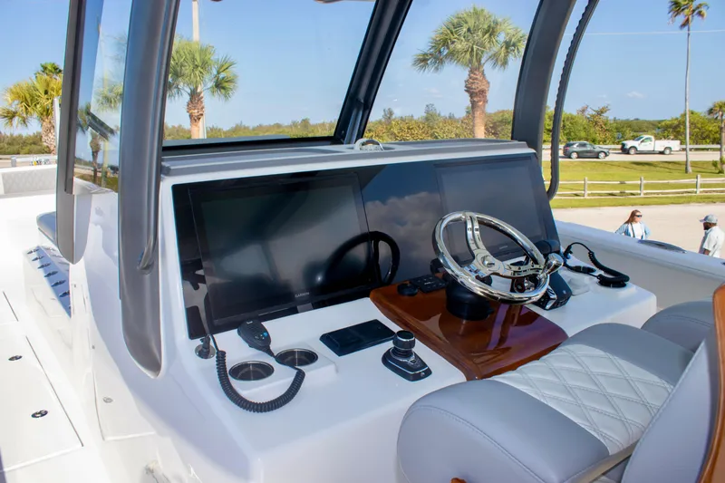 Slide: The Image of 2026 Front Runner 43 Catamaran helm with modern controls and steering wheel. - 13
