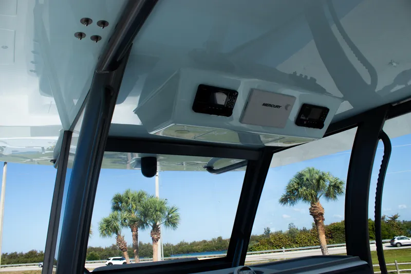 Slide: The Image of 2026 Front Runner 43 Catamaran interior with electronics, featuring a sleek design and palm trees outside. - 22