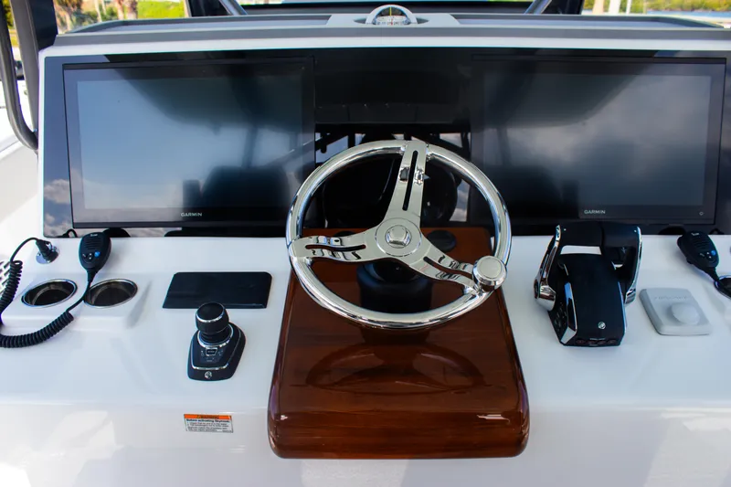 Slide: The Image of Helm of 2026 Front Runner 43 Catamaran with modern controls and dual screens. - 27