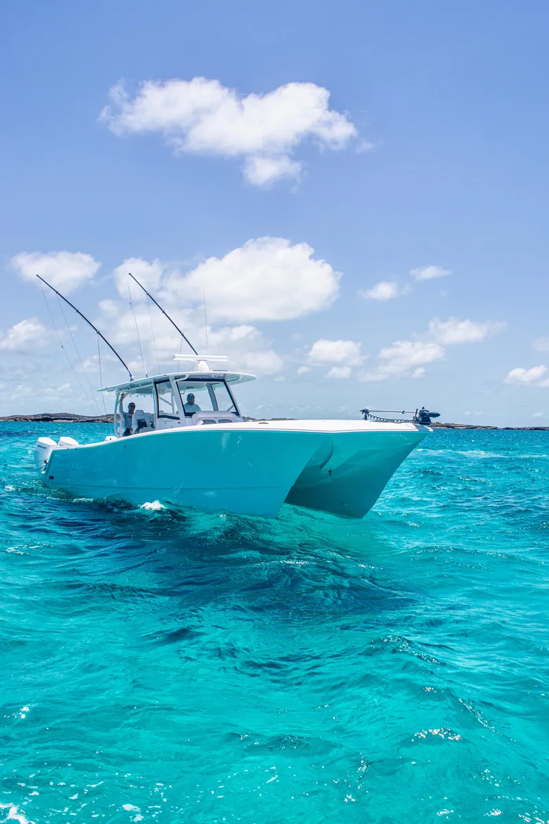 Slide: The Image of Front Runner 43 Catamaran 2026 cruising on clear turquoise waters under a bright blue sky. - 3