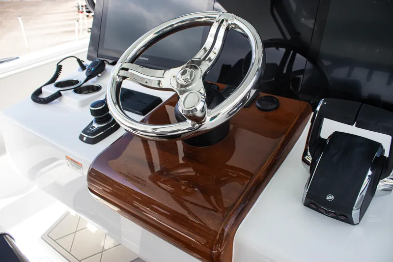 Slide: The Image of Steering wheel and controls of 2026 Front Runner 43 Catamaran, featuring sleek design and modern technology. - 34