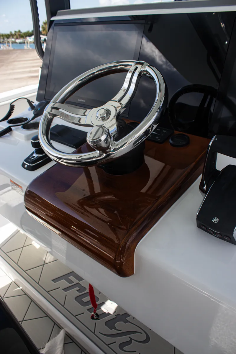 Slide: The Image of Steering wheel of 2026 Front Runner 43 Catamaran with modern dashboard controls. - 35