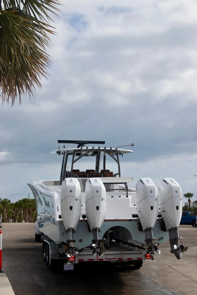 Slide: The Image of Front Runner 43 Catamaran 2026 with four outboard engines on a trailer, parked near palm trees. - 40