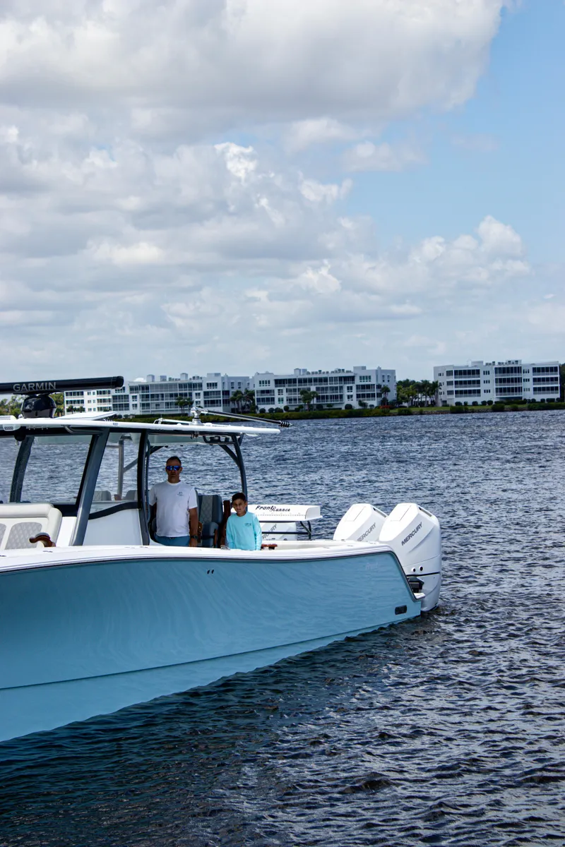 Slide: The Image of 2026 Front Runner 43 Catamaran cruising on a sunny day with modern buildings in the background. - 41