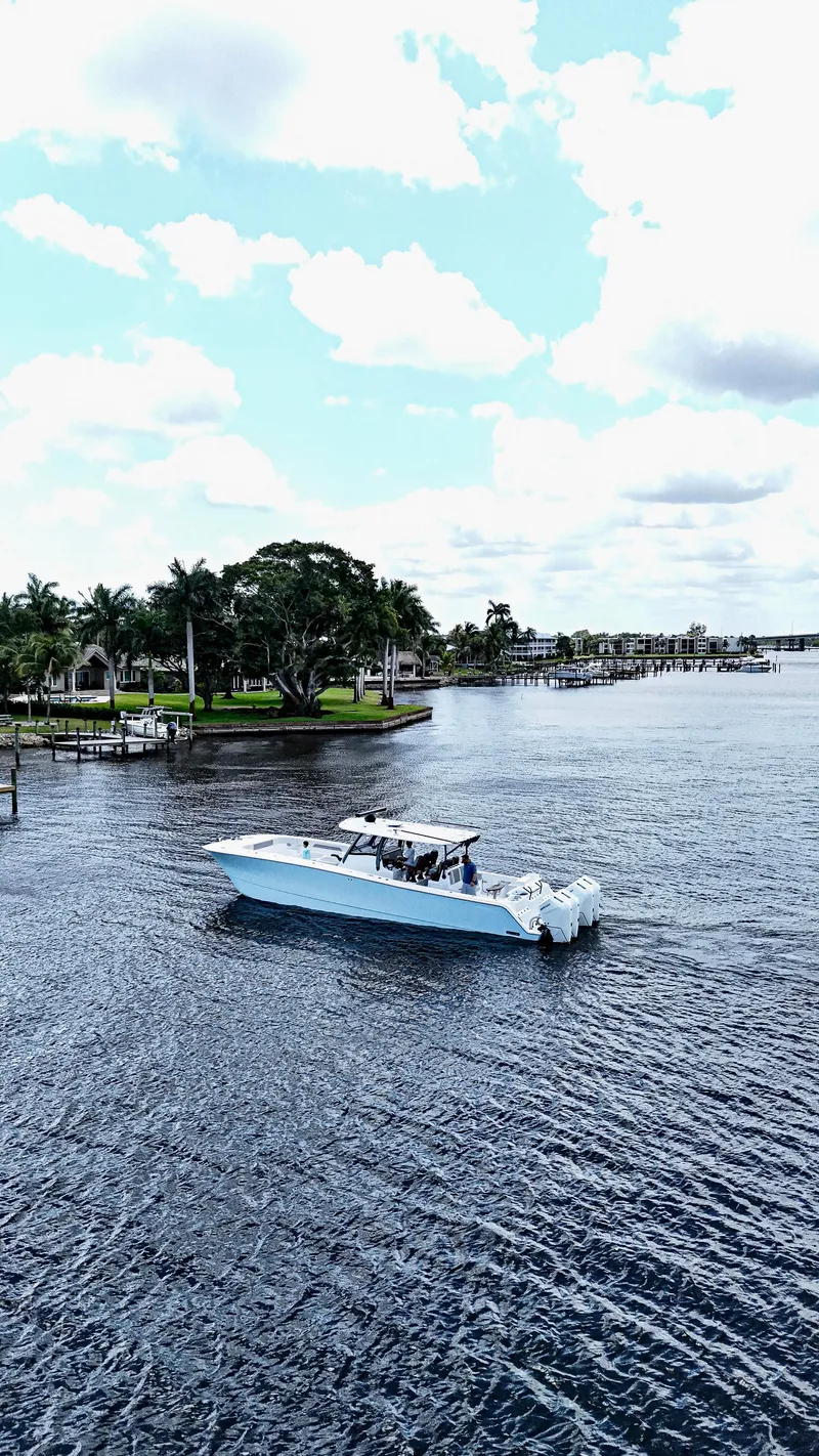 Slide: The Image of 2026 Front Runner 43 Catamaran cruising on a scenic waterway with lush greenery. - 8