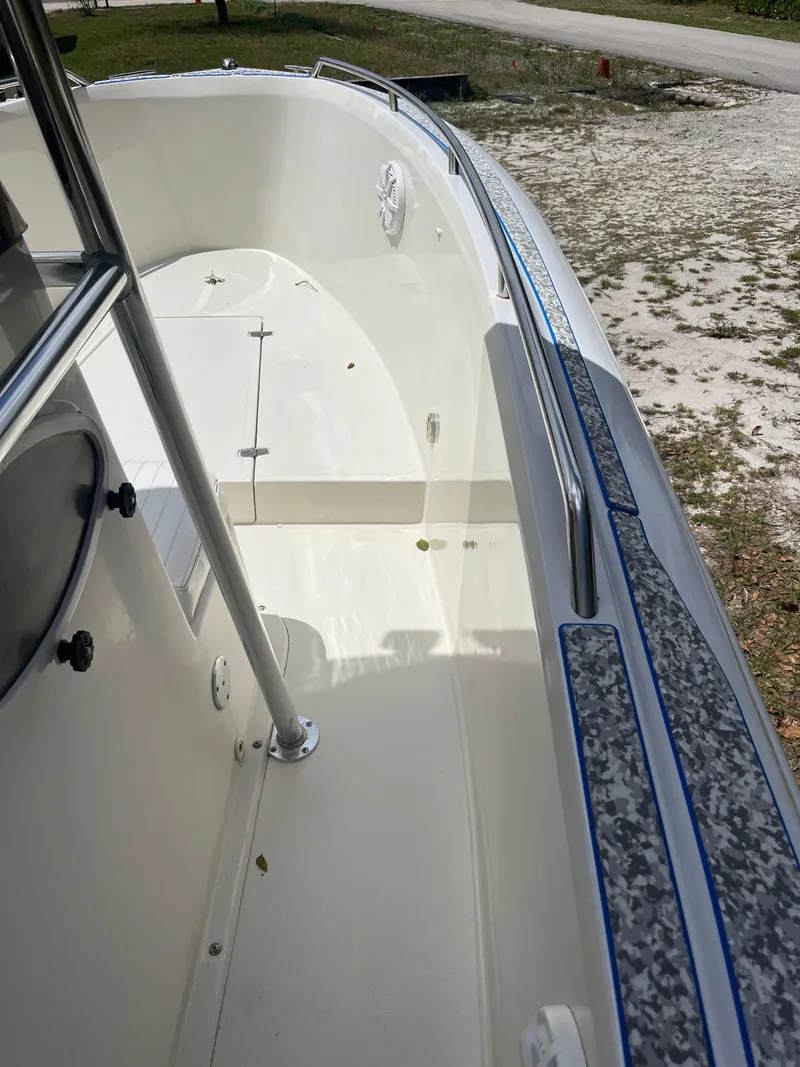 Slide: The Image of 1998 Blue Fin 25 Center Console boat deck, featuring clean white surfaces and sturdy railings. - 10