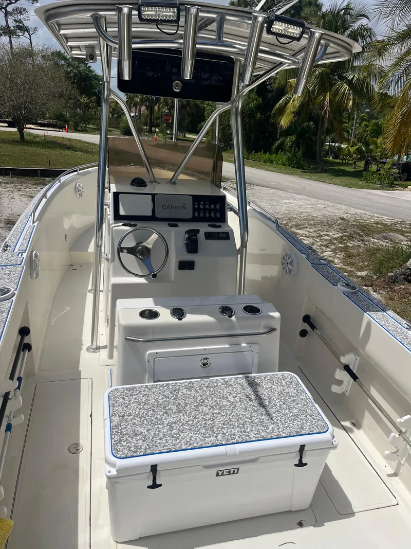 Slide: The Image of 1998 Blue Fin 25 Center Console boat with modern controls and seating, set outdoors. - 3