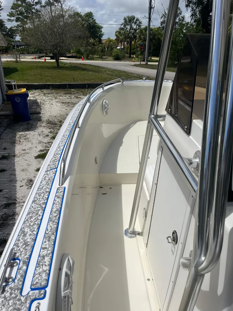 Slide: The Image of 1998 Blue Fin 25 Center Console boat, white interior, stainless steel railings, outdoor setting. - 4
