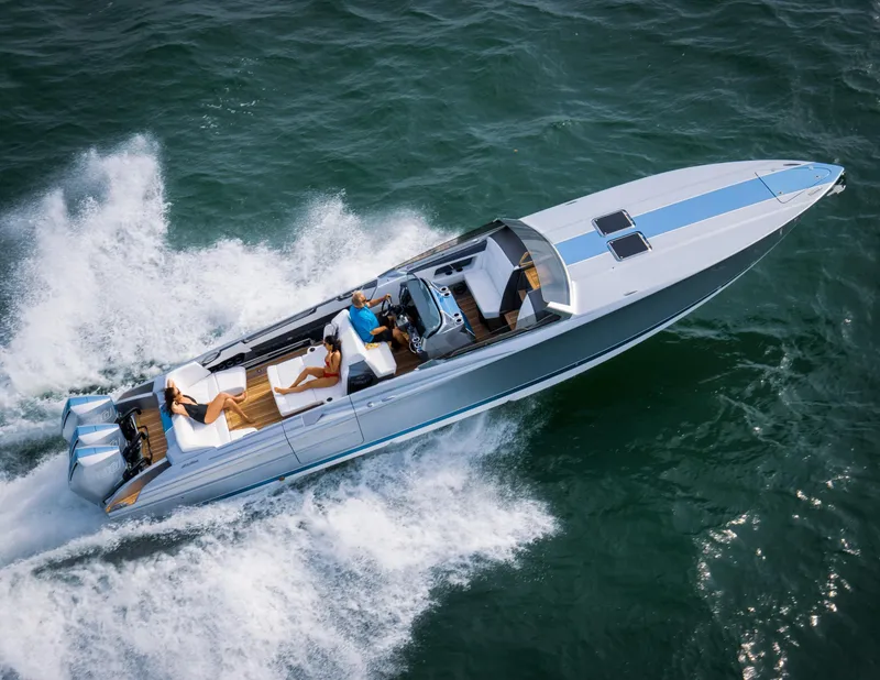 Slide: The Image of 2005 Nor-Tech 420 Monte Carlo speedboat cruising on open water, aerial view. - 2