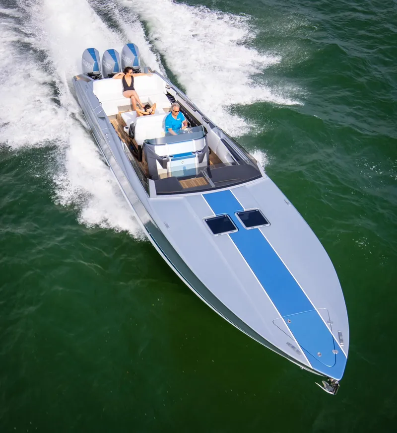 Slide: The Image of 2005 Nor-Tech 420 Monte Carlo speedboat cruising on open water, featuring sleek design and powerful engines. - 4