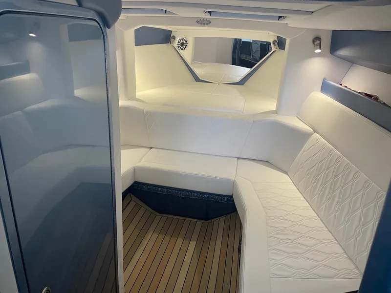 Slide: The Image of Luxurious interior of 2025 Nor-Tech 420 Monte Carlo with white seating and wood flooring. - 6