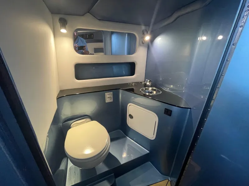 Slide: The Image of Modern bathroom interior of 2025 Nor-Tech 420 Monte Carlo boat, featuring sleek design and compact amenities. - 7