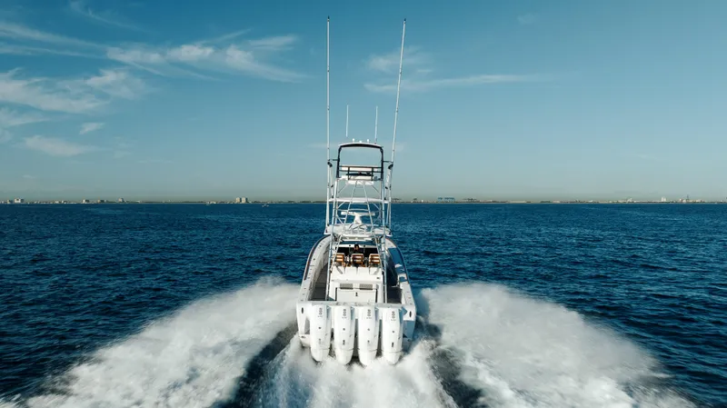 Slide: The Image of 2026 Front Runner 47 Center Console boat cruising on open water, leaving a wake. - 21