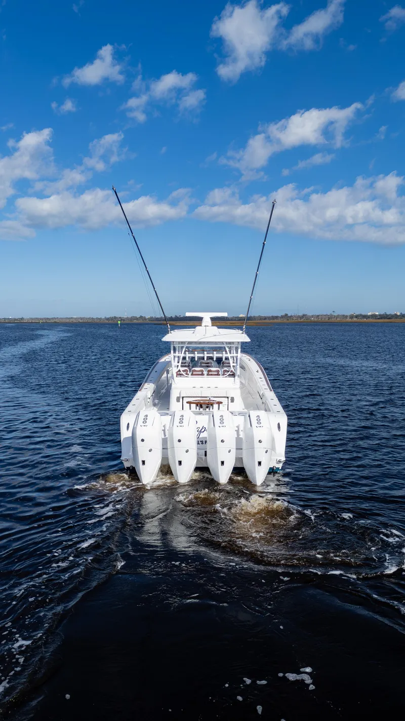 Slide: The Image of 2026 Front Runner 47 Center Console boat cruising on open water under blue sky. - 23