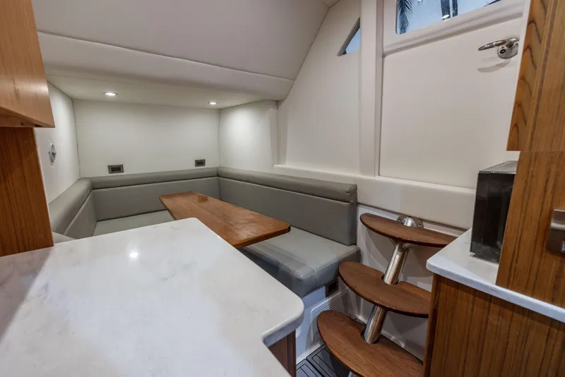 Slide: The Image of Luxurious interior of 2026 Front Runner 47 Center Console with modern seating and wooden accents. - 27