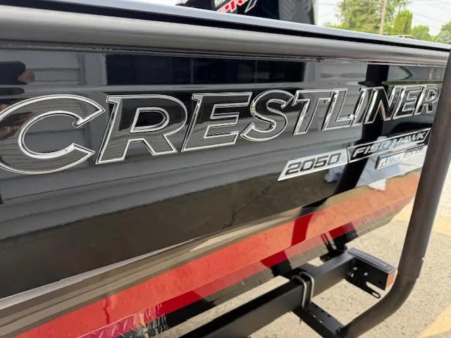 Slide: The Image of 2025 Crestliner 2050 Fish Hawk boat, black exterior with red accents, close-up view. - 10