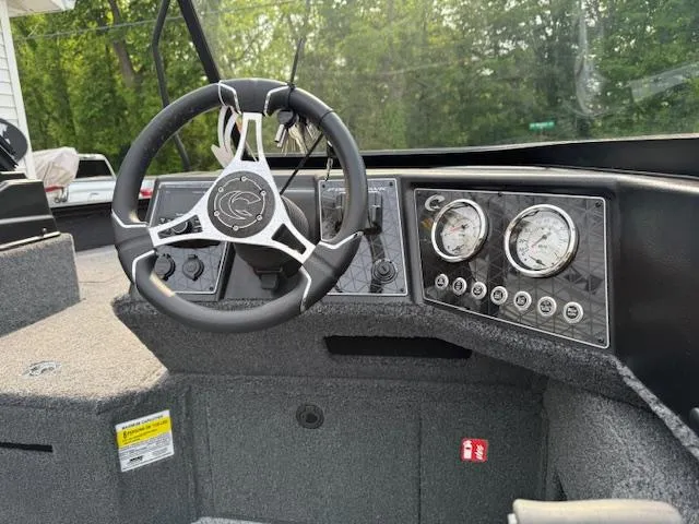 Slide: The Image of 2025 Crestliner 2050 Fish Hawk dashboard with steering wheel and gauges. - 5