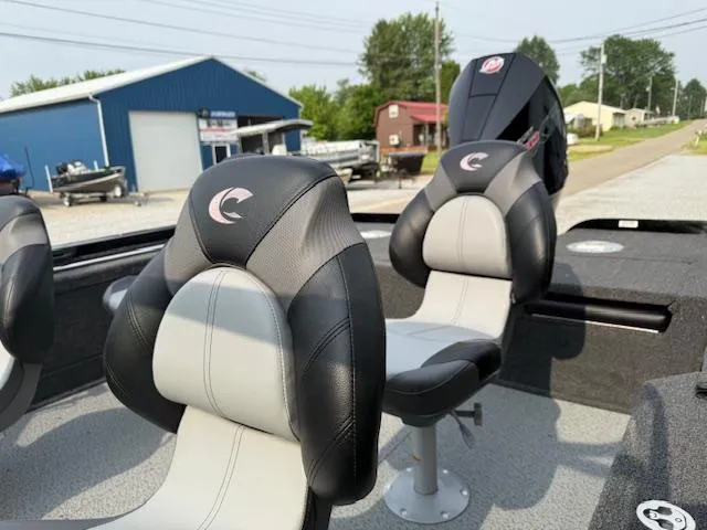 Slide: The Image of 2025 Crestliner 2050 Fish Hawk boat seats with logo, outdoor setting. - 7
