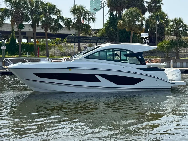 The Image of 2022 Beneteau Gran Turismo 32 yacht docked near palm trees. - 0