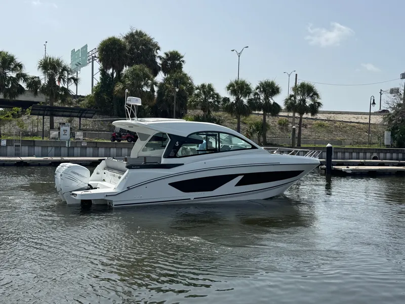 Slide: The Image of 2022 Beneteau Gran Turismo 32 yacht docked in a marina with palm trees. - 10