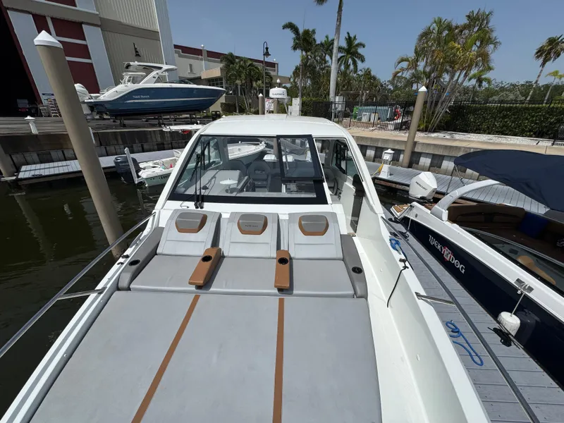 Slide: The Image of 2022 Beneteau Gran Turismo 32 yacht docked, featuring spacious sunbathing area and sleek design. - 14