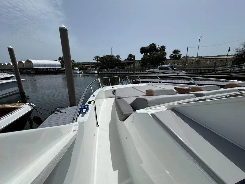 Slide: The Image of 2022 Beneteau Gran Turismo 32 docked at marina, showcasing sleek design and spacious deck. - 16