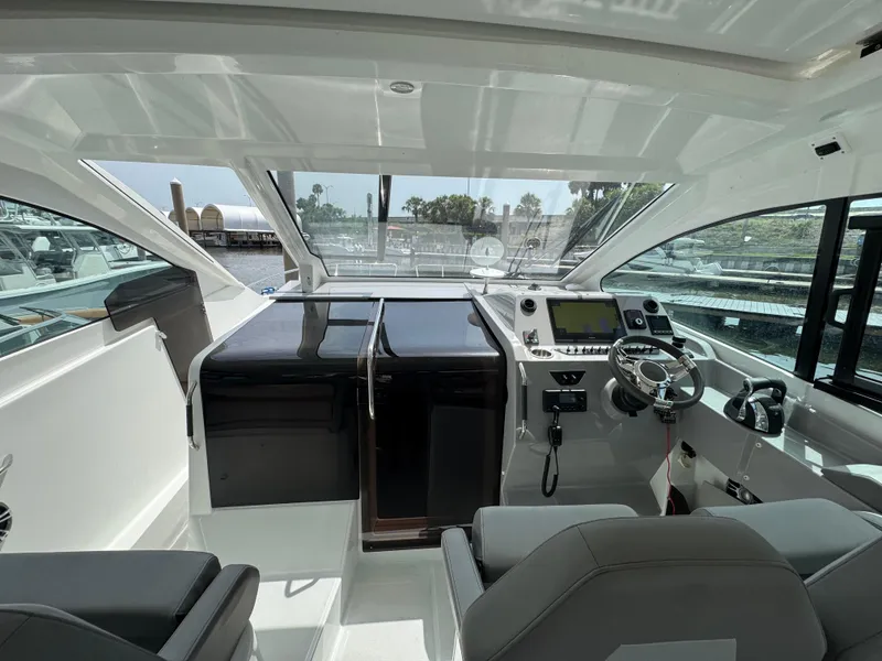 Slide: The Image of 2022 Beneteau Gran Turismo 32 cockpit with modern controls and panoramic windows. - 17