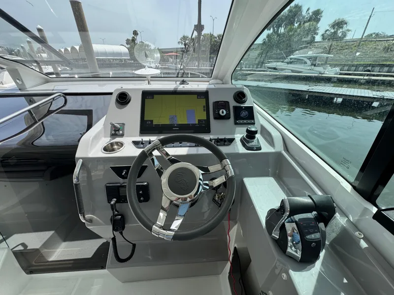 Slide: The Image of Cockpit of 2022 Beneteau Gran Turismo 32 with steering wheel and navigation display. - 18