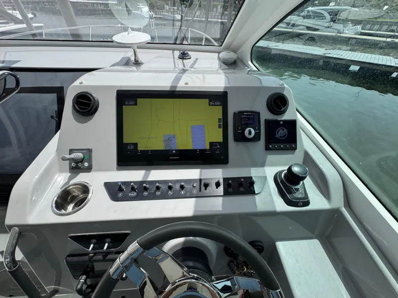 Slide: The Image of Control panel of 2022 Beneteau Gran Turismo 32 yacht with navigation display and controls. - 19