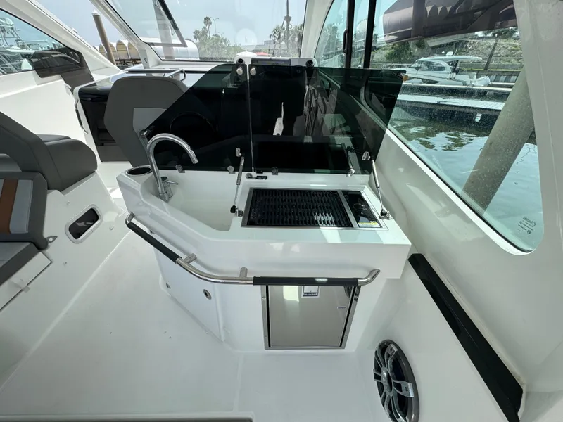 Slide: The Image of 2022 Beneteau Gran Turismo 32 yacht interior with kitchenette and seating area. - 22