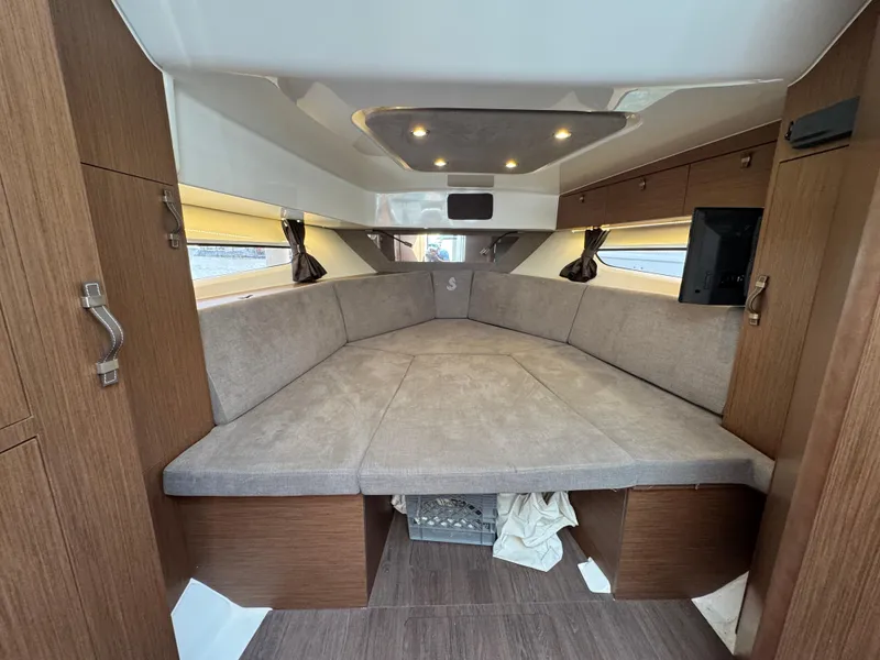 Slide: The Image of Interior cabin of 2022 Beneteau Gran Turismo 32 yacht, featuring cozy seating and modern design. - 28